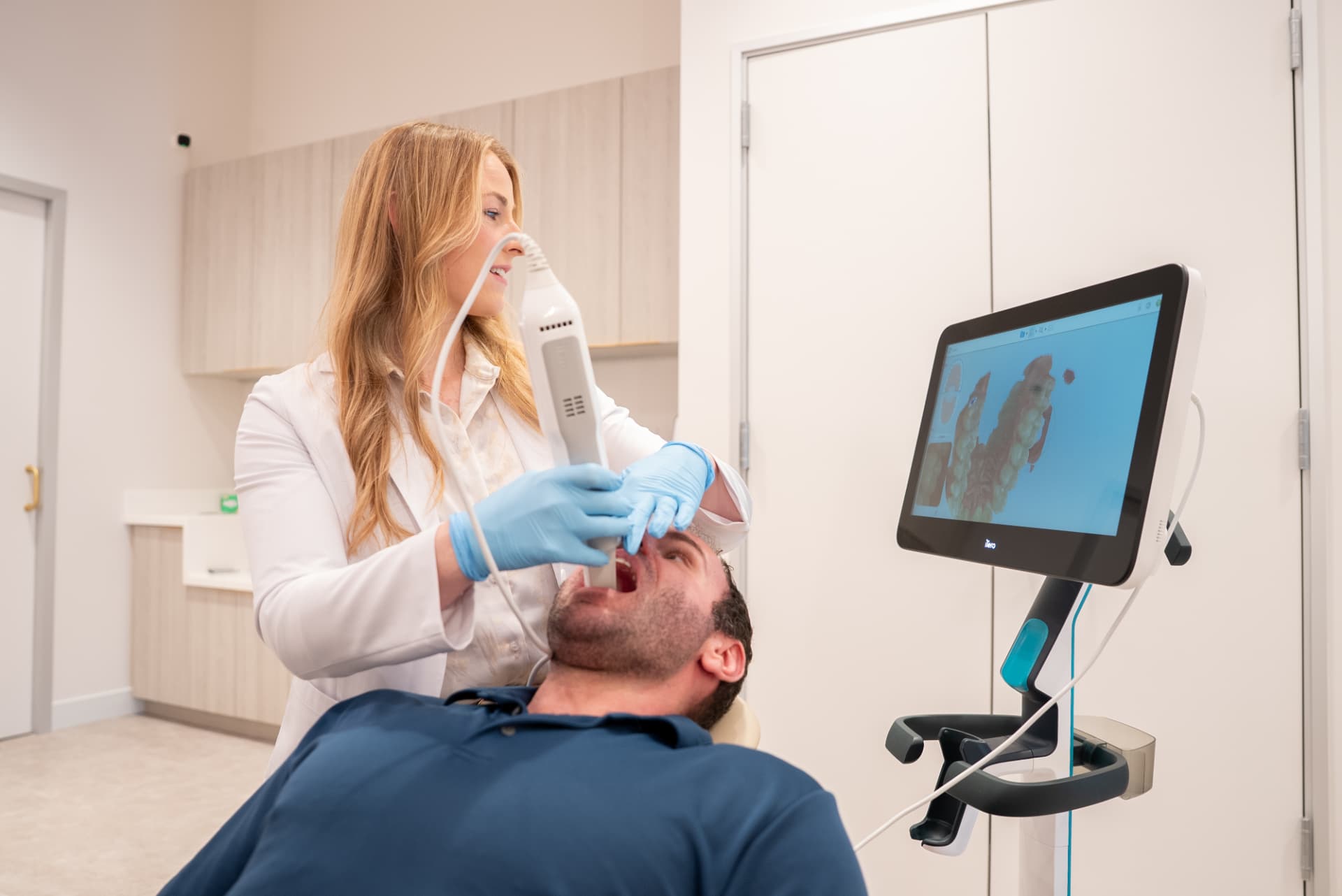 Dr. Nicole using a digital scanner during a complimentary Invisalign consultation at SCAND Orthodontic Studio